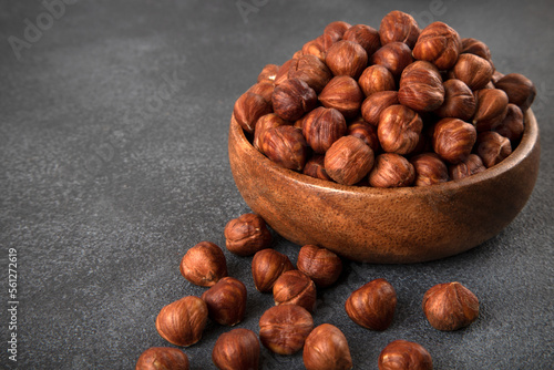 View of a bowl full of hazelnuts on a dark background