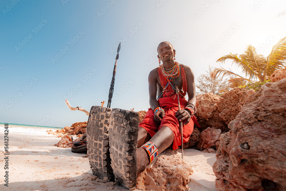Maasai warrior on the beach Diani Beach, Kenya Mombasa January 26 2012 - obrazy, fototapety, plakaty 