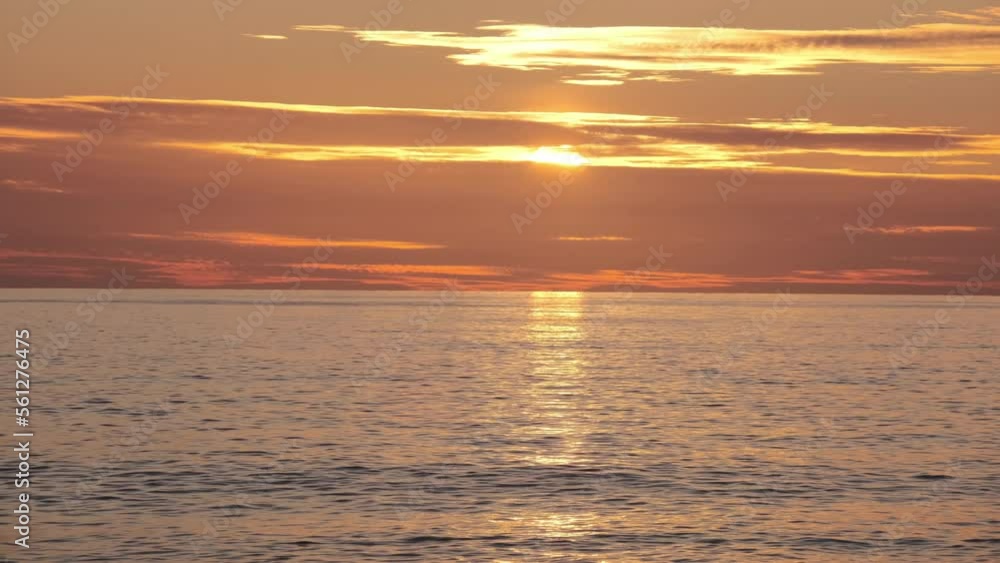 Sunset over the sea in warm colors, the middle plan Sunset over the sea in warm colors, the middle plan