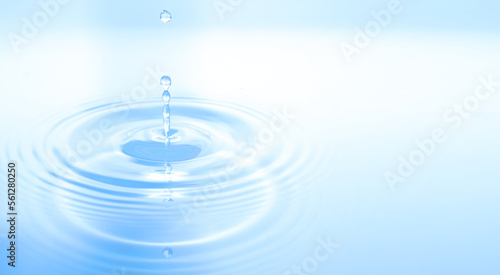 Waves of water are caused by falling droplets. close-up view.