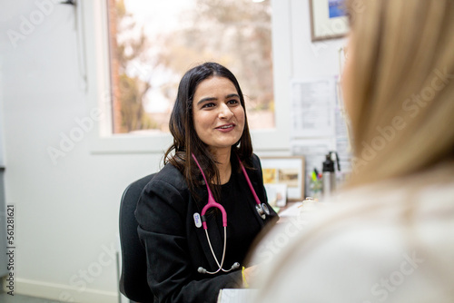 Doctor talks to her patient in her consulting room