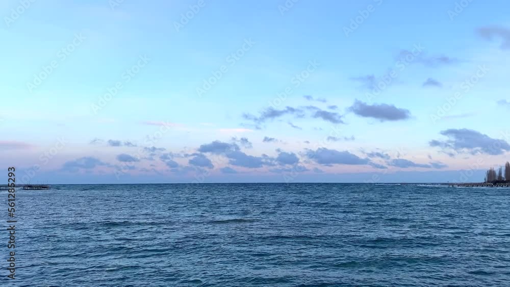 Beautiful view of the amazing mountain lake at sunset. The pearl of Kyrgyzstan is Lake Issyk-Kul. Calm calming natural background. Summer landscape. Beautiful view of the amazing mountain lake at sunset. The pearl of Kyrgyzstan is Lake Issyk-Kul. Calm calming natural background. Summer landscape.
