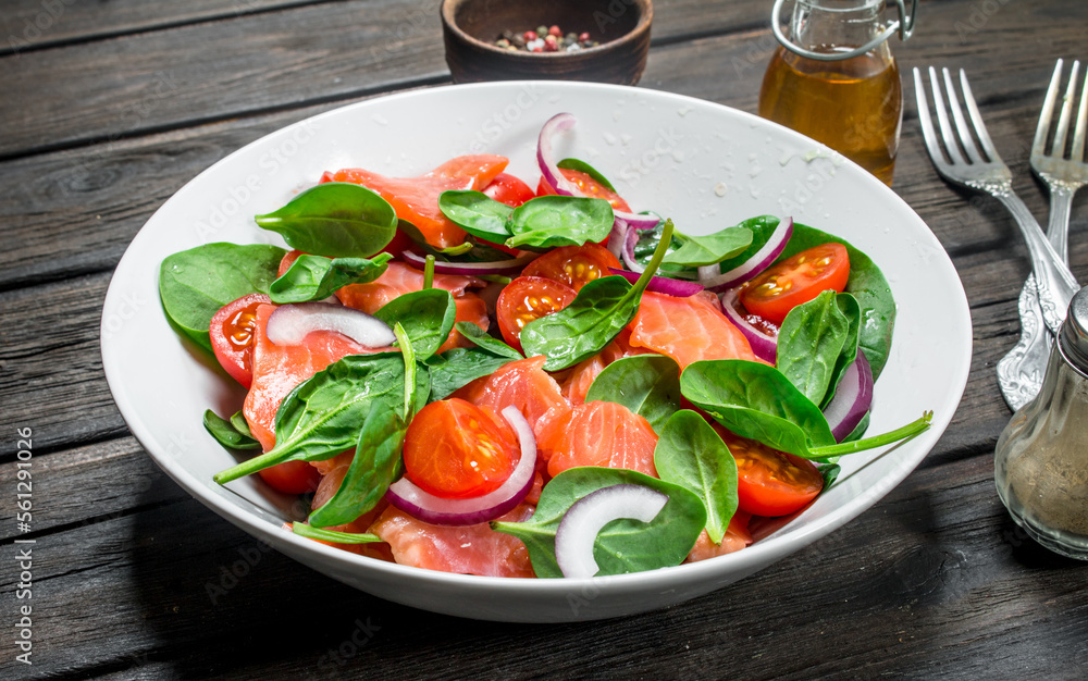 Fish salad. Salad with slices of salmon, tomatoes and spinach with lime juice. Fish salad. Salad with slices of salmon, tomatoes and spinach with lime juice.