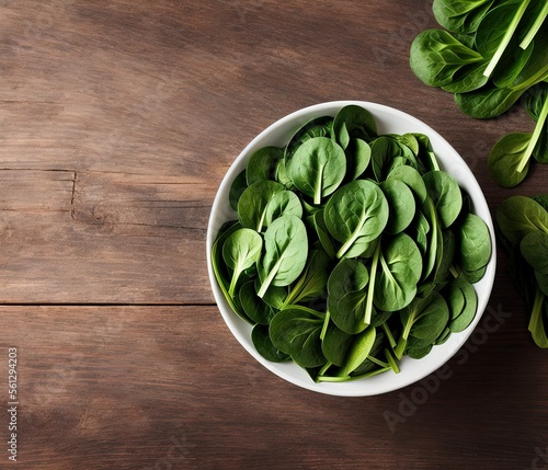 fresh green spinach leaves on a wooden background. top view.