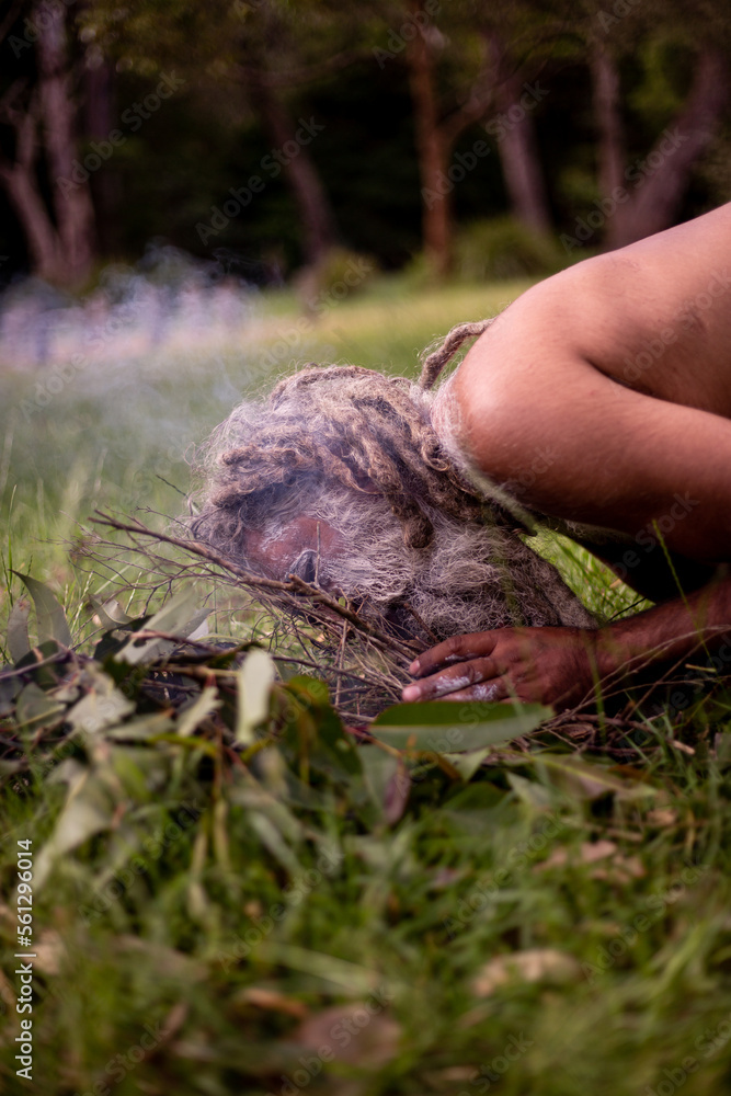 Aboriginal man starting a smoking ceremony Aboriginal man starting a smoking ceremony