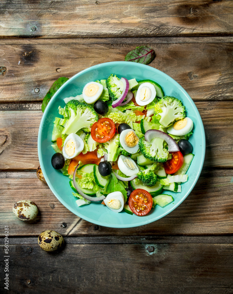 Vegetable salad. Tomato, cucumber and quail egg salad with olive oil and Basil.