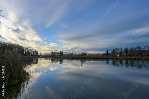 Early morning landscape scene with clouds reflecting in water, Reuss, Flachsee, Switzerland.