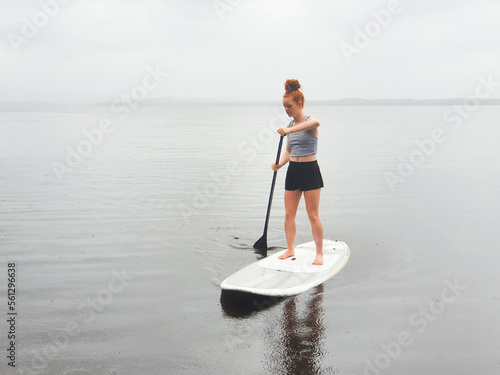 Teenage girl on a stand up paddle board