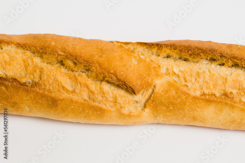 French baguette on a white background with copy space. Delicious appetizing crust of a bun close-up