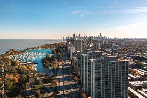 Beautiful aerial cityscape view of downtown Chicago above Lake Shore Drive with Belmont Harbor and residential highrise buildings in the Lakeview neighborhood in the foreground on a sunny fall day.