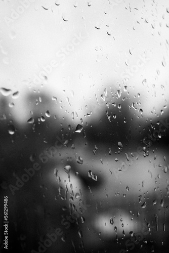 some large raindrops are on a window pane