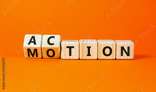 Action or motion symbol. Concept word Motion and Action on wooden cubes. Beautiful orange table orange background. Business and action or motion concept. Copy space.