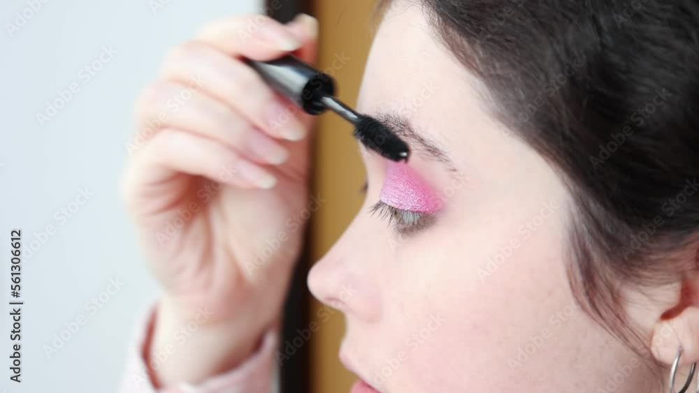 Close-up of woman coloring eyelashes. Eye makeup concept Close-up of woman coloring eyelashes. Eye makeup concept