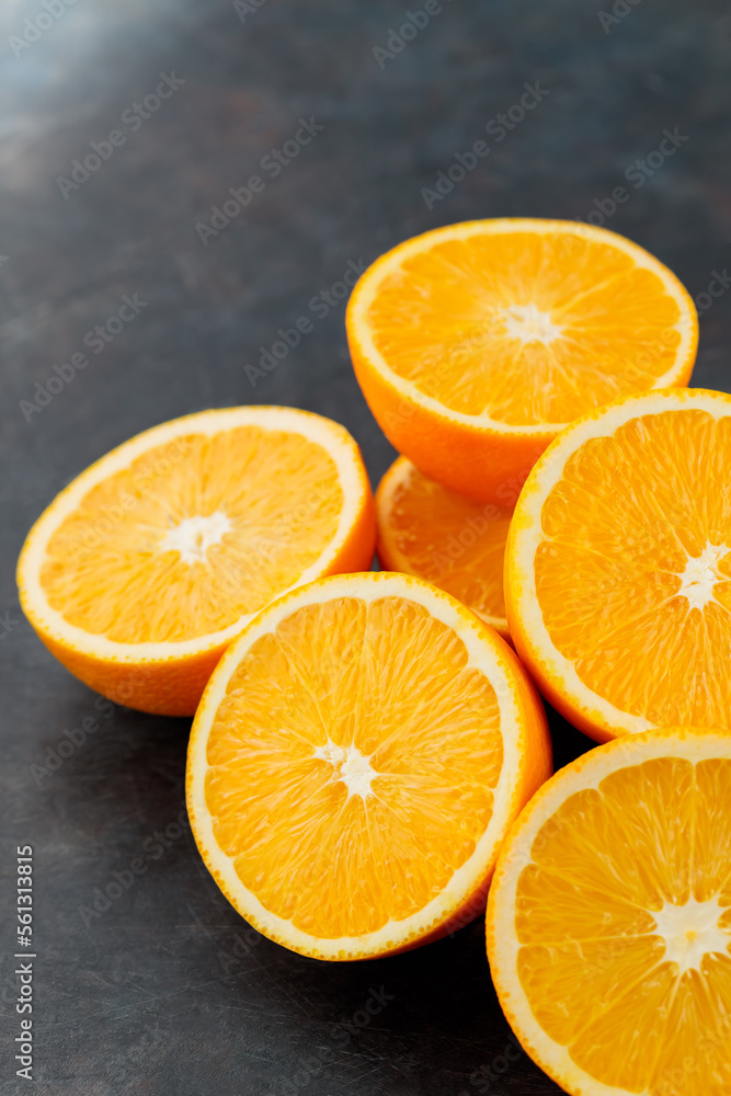 Orange slices on a black background. Halves of juicy oranges for a healthy diet Orange slices on a black background. Halves of juicy oranges for a healthy diet