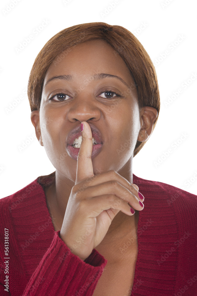 african woman with finger on the lips signing keep quiet