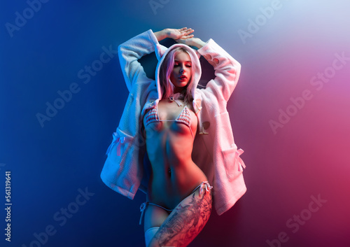 Fototapeta sexy girl in underwear in neon lights on a uniform neon background place copy pa