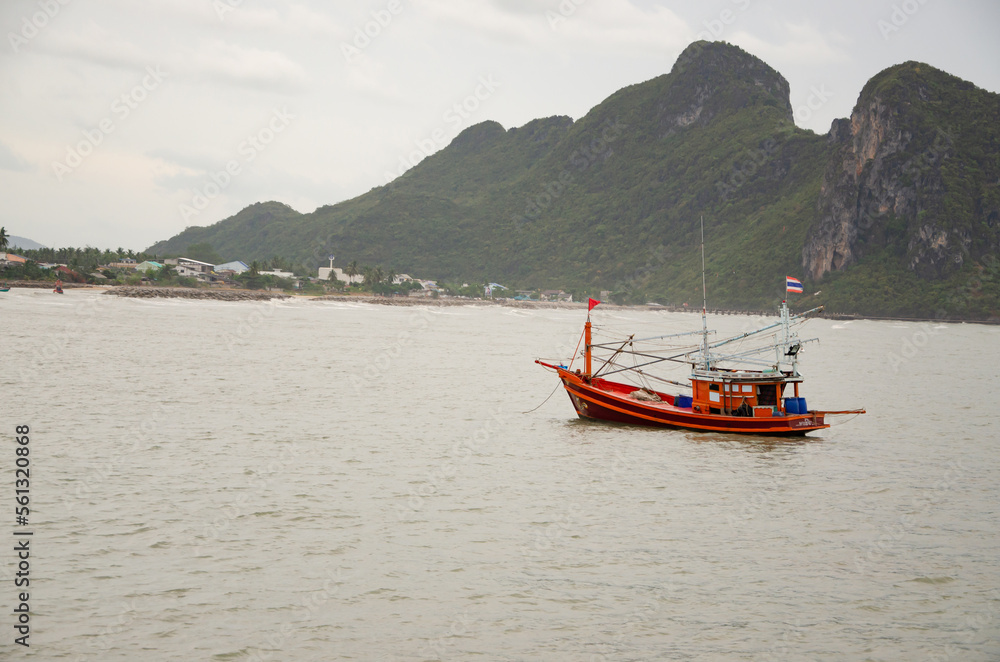 Coastal fishing boats are floating by the sea.