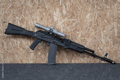 Assault rifle with a telescopic sight, close-up photo.