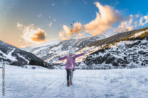 Young skier, girl having fun on the snow, throwing snow powder up. Winter ski holidays in Andorra, El Tarter, Pyrenees Mountains, Grandvalira photo