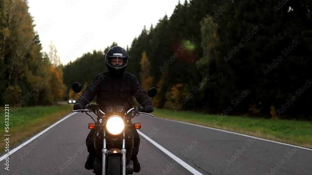 riding a motorcycle on a forest road, motorcyclist journey. riding a motorcycle on a forest road, motorcyclist journey.