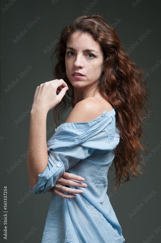 Fototapeta premium young redhead female model on plain background with copyspace