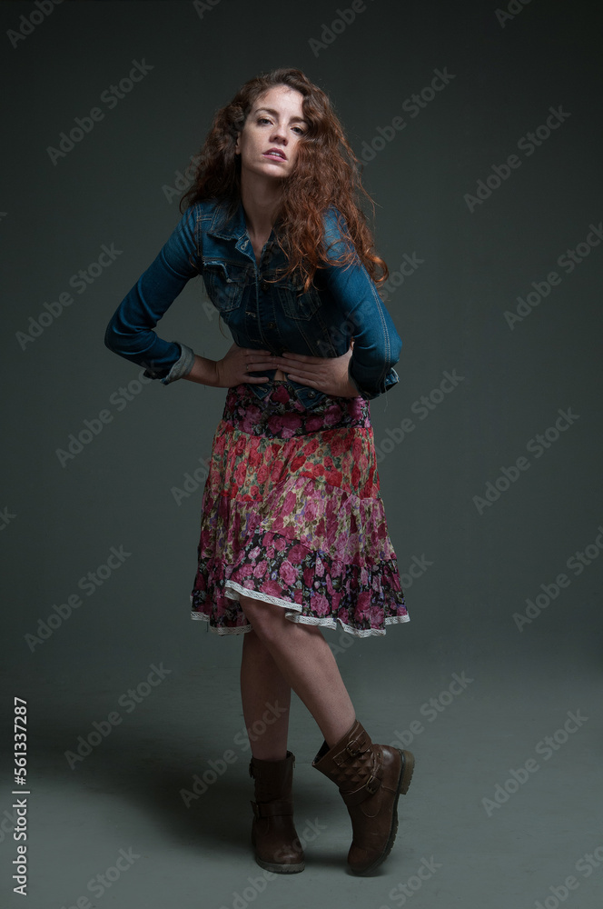 young redhead female model on plain background with copyspace