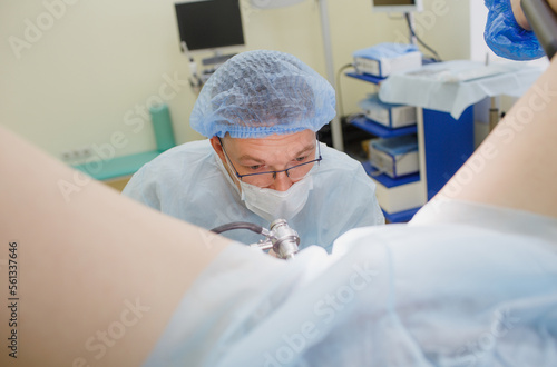 a proctologist examines a rectal colonoscopy patient lying on a medical chair in the surgical office. Rectal examination.
