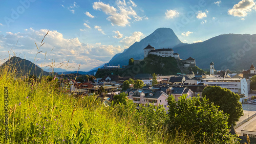Cityscape of Kufstein, Austria with the Kufstein castle on a hill and the Pendling Mountain in the background.
