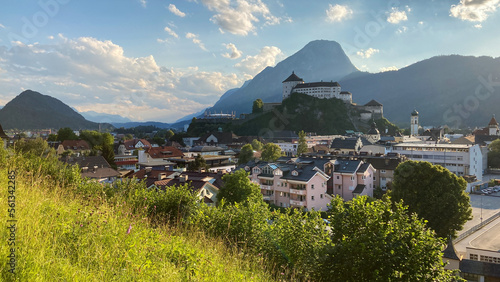 Cityscape of Kufstein, Austria with the Kufstein castle on a hill and the Pendling Mountain in the background.