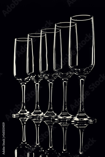 glass goblets outlined with light on a black background