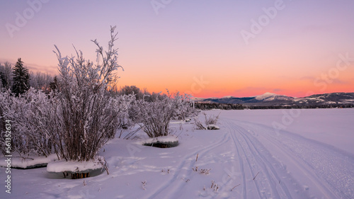Winter landscape views along the Yukon River during January with stunning pastel orange, pink sunset views.  © Scalia Media