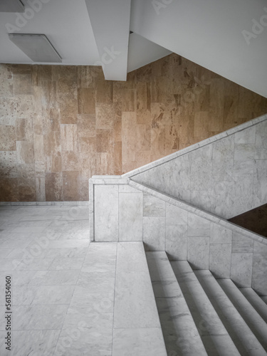 Marble stairs on the background of a marble-tiled wall side view.