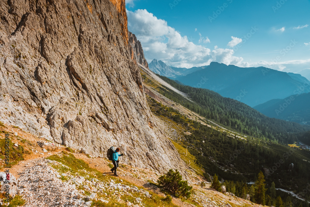hiking sport woman in mountains Sella Ronda, Dolomites, Italy