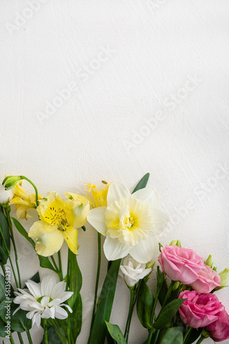 Top view of spring flowers on light surface