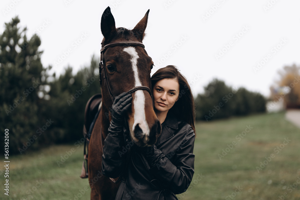 Obraz premium Horse riding. A young woman with a horse.