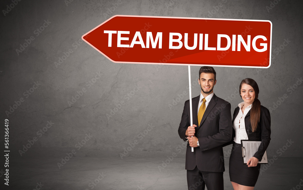 Young business person in casual holding road sign Young business person in casual holding road sign