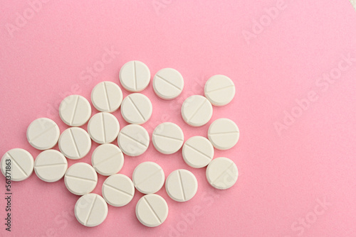 Pills. Drugs for health. Medication tablets are capsized on the tablets. Various pharmaceutical medicine pills, tablets and capsules on pink background
