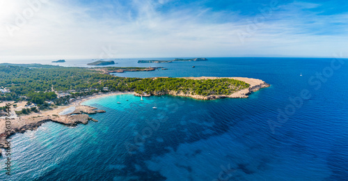 Ibiza Cala Bassa beach with turquoise water, aerial views