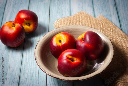 Fresh red nectarines. Wooden background.