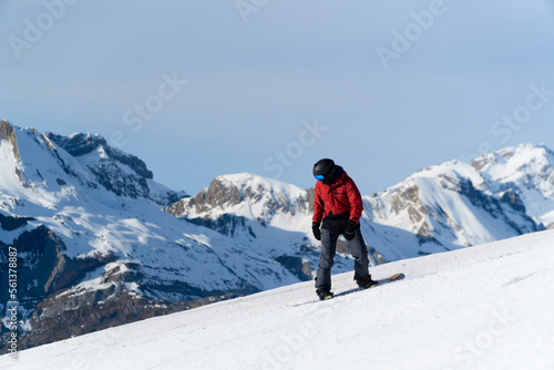 man snowboarding on the mountain on a sunny day