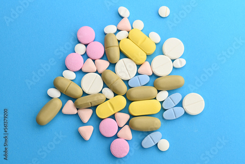 Pills. Drugs for health. Medication tablets are capsized on the tablets. Various pharmaceutical medicine pills, tablets and capsules on blue background