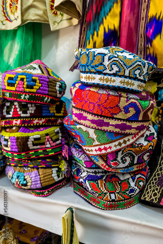Skullcap, "tubereika". A lot of knitted ethnic hats: skullcaps on counter of shop, store in Uzbekistan. Traditional national Uzbek headdress, costume, dress, handicraft. Tubeteyka