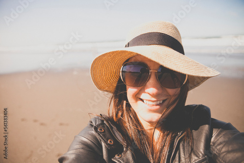 Close-up portrait of woman standing at beach photo