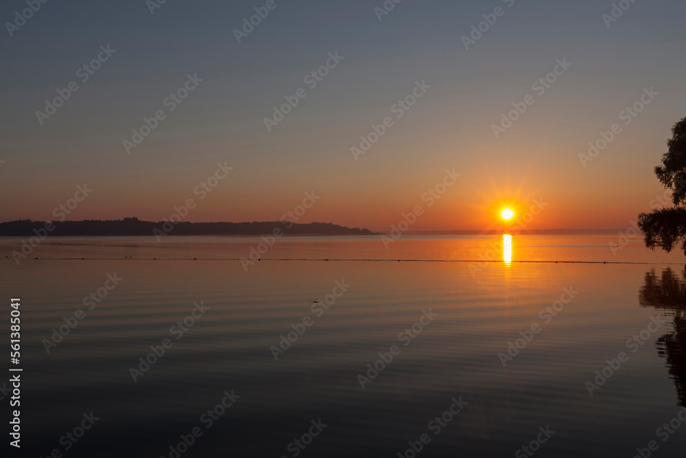 Sun shining over Chiemsee lake, Bavaria, Germany Sun shining over Chiemsee lake, Bavaria, Germany