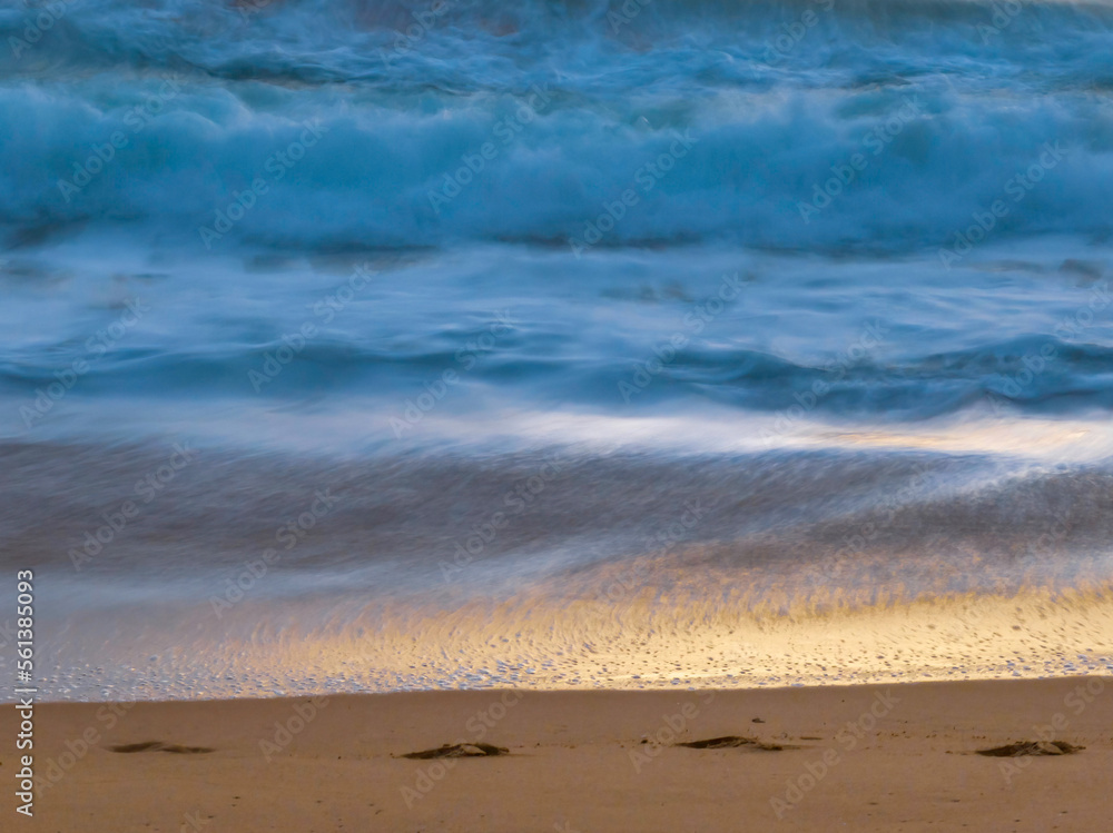 Top down sunrise and footprints in the sand