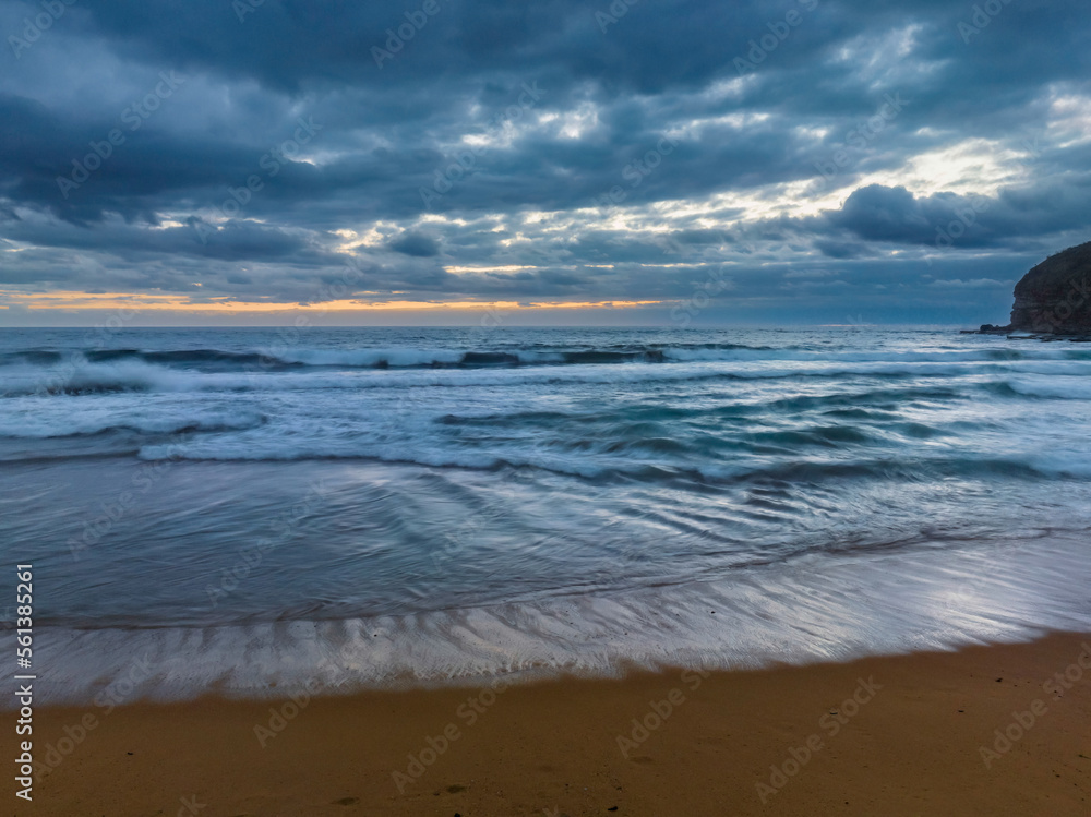 Sunrise over the ocean with rain clouds