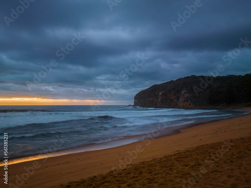 Sunrise over the ocean with rain clouds