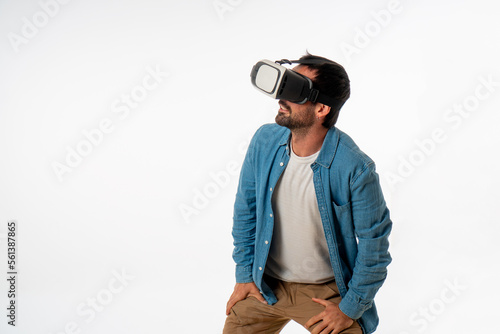 young handsome man with virtual reality goggles on white background. studio photo