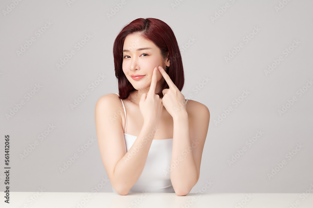 Beautiful young asian woman with clean fresh skin on grey background, Face care, Facial treatment, Cosmetology, beauty and spa, Asian women portrait. Beautiful young asian woman with clean fresh skin on grey background, Face care, Facial treatment, Cosmetology, beauty and spa, Asian women portrait.