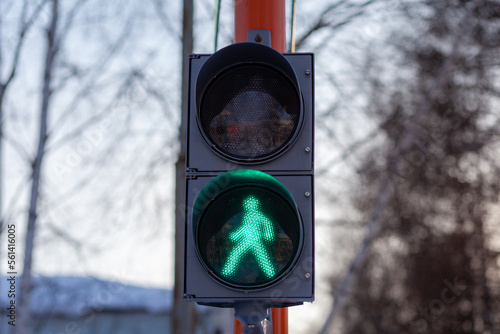 Green light on a pedestrian traffic light. Safe crossing of the road by pedestrians. 